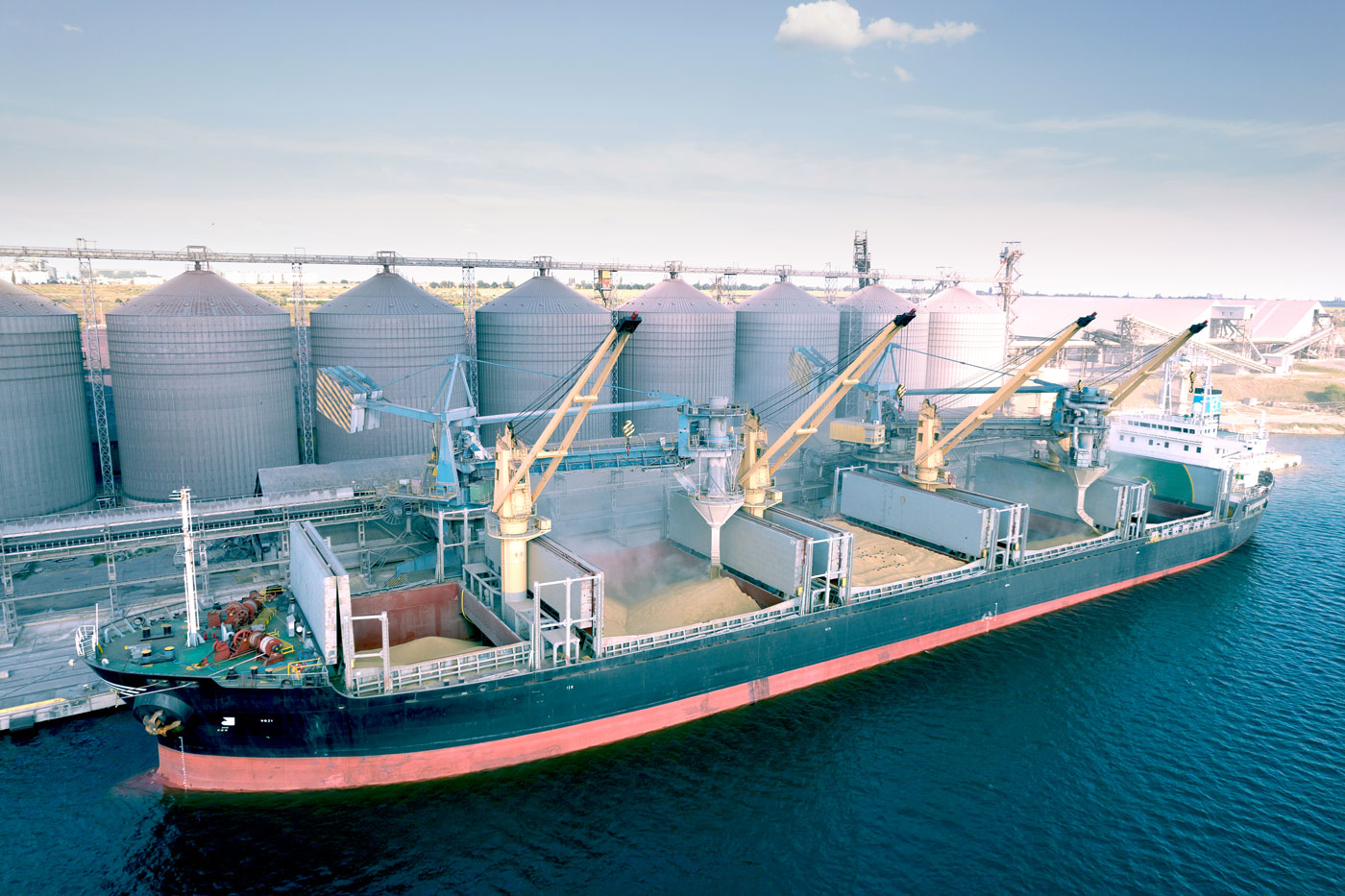 grain ship docked with grain bins in background